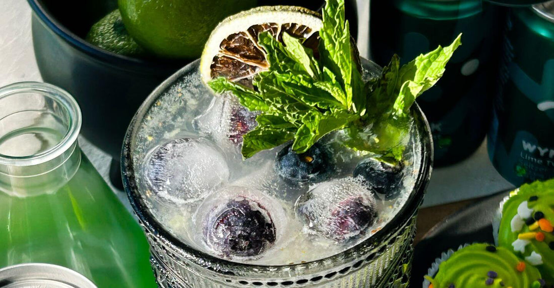 Halloween-themed mocktail garnished with blackberries, jalapeño, and thyme, made with Wynk Black Cherry THC-infused seltzer for a hangover-free festive drink.