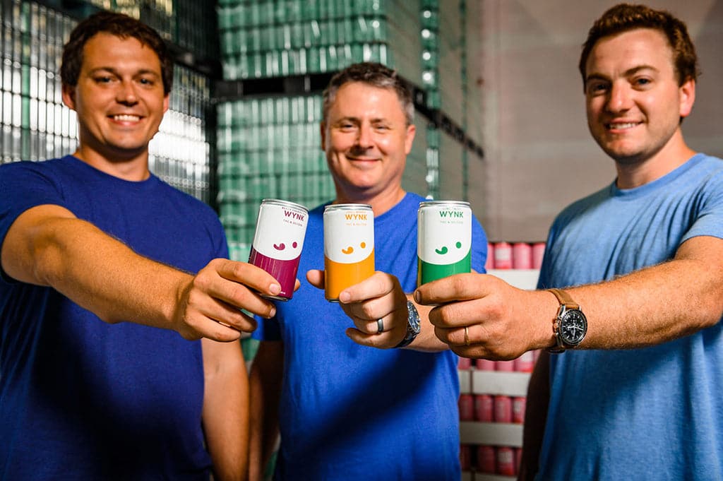 Wynk founders holding cans of infused cannabis seltzers